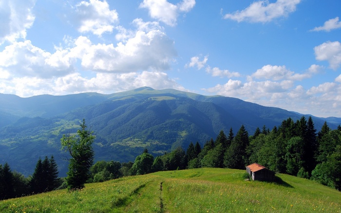 Mountain landscape with a small cabin