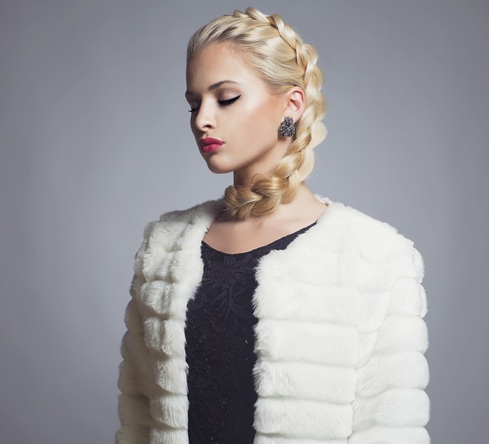 Blonde woman with braid and white fur coat