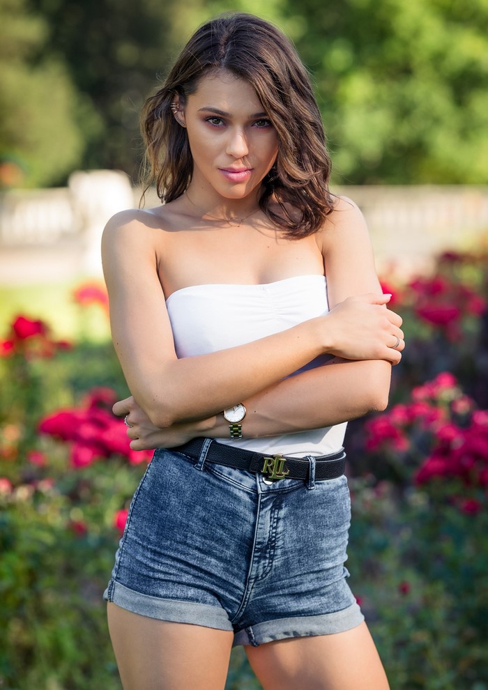 Agnieszka Borkowska in white top and denim shorts