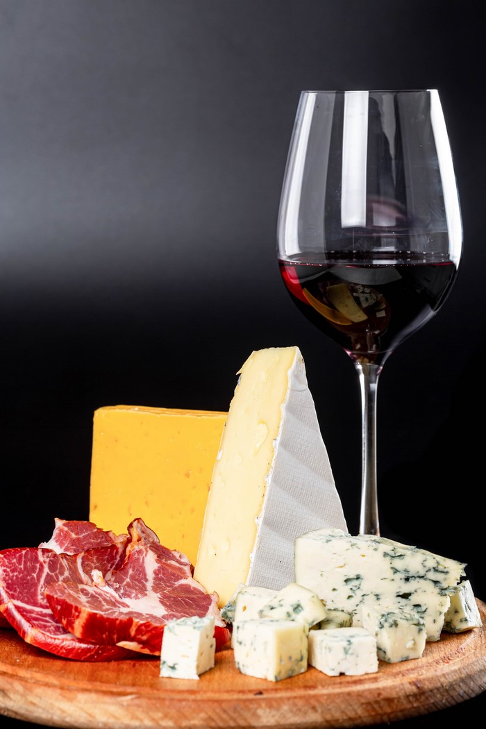 Wine and cheese platter with cured meat
