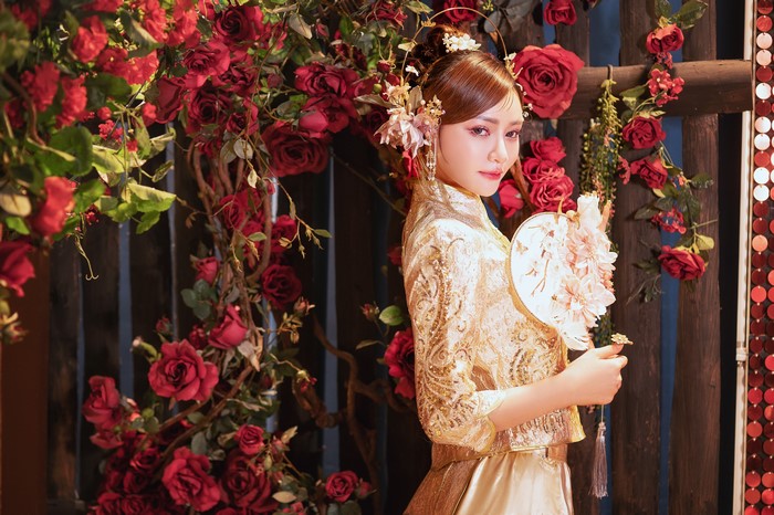 Asian woman in traditional dress with roses