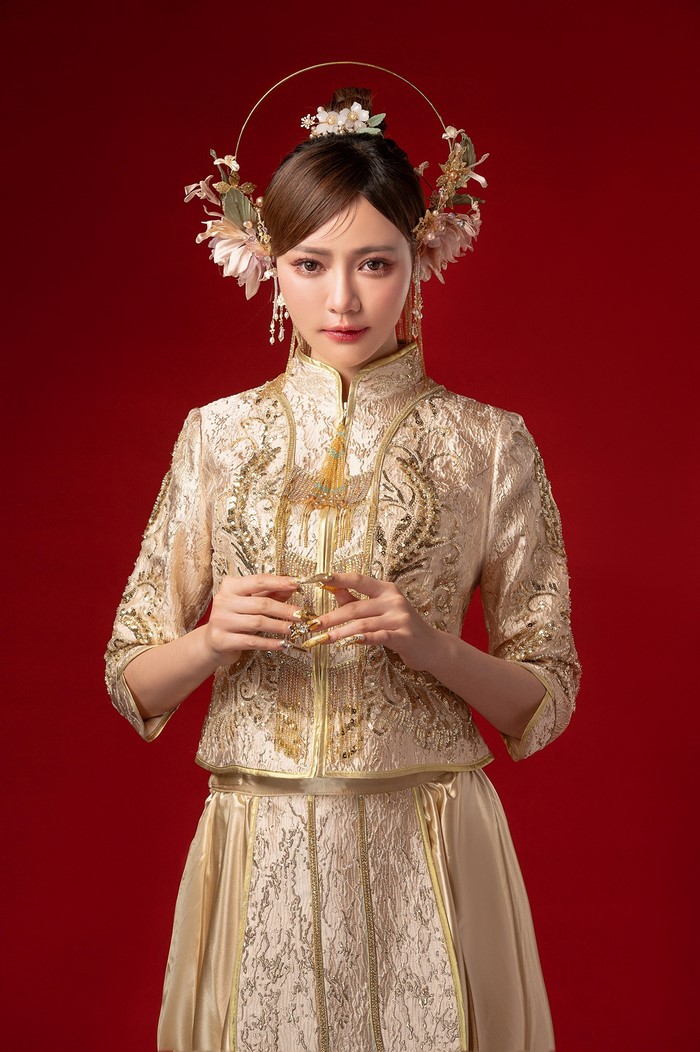 Woman in traditional Chinese wedding dress with elaborate headpiece