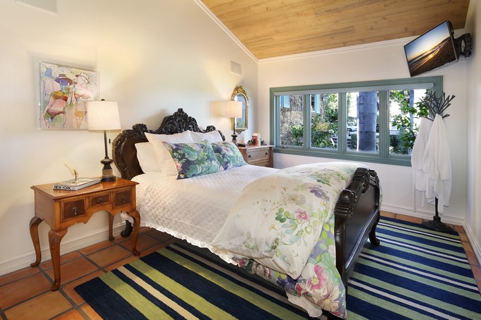 Bedroom with bed, lamps, and window