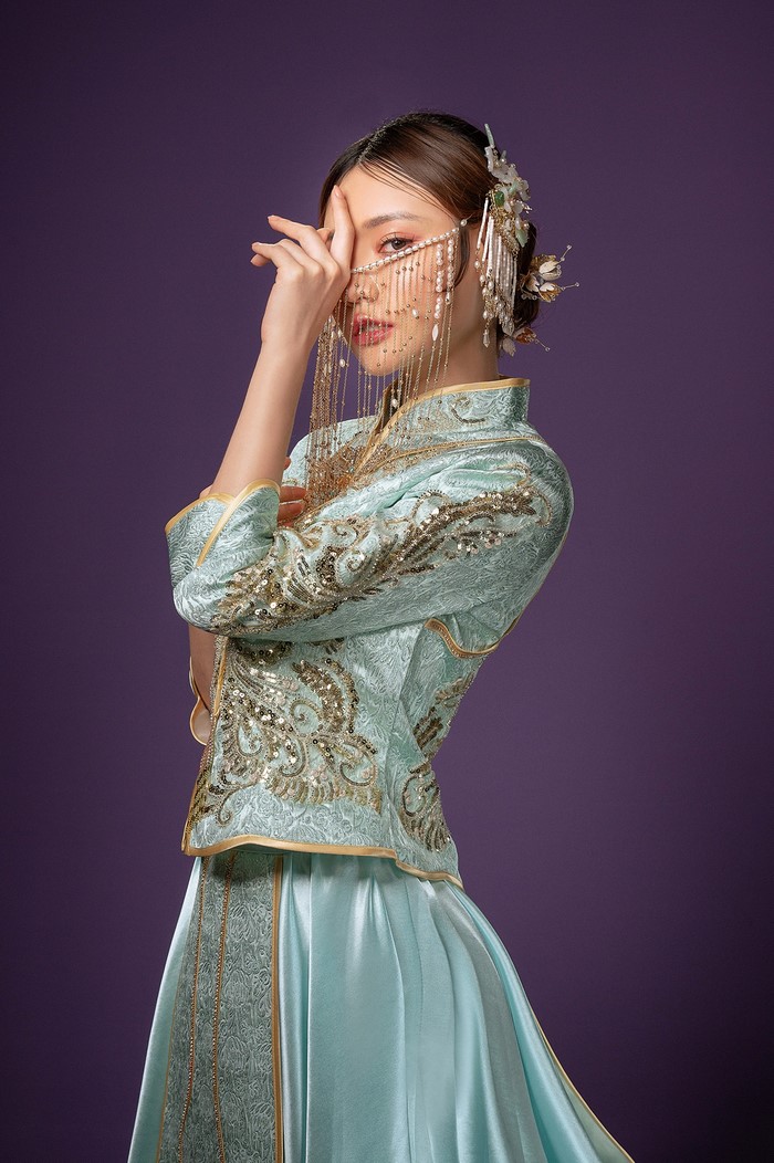 Woman in traditional Asian dress with veil and jewelry
