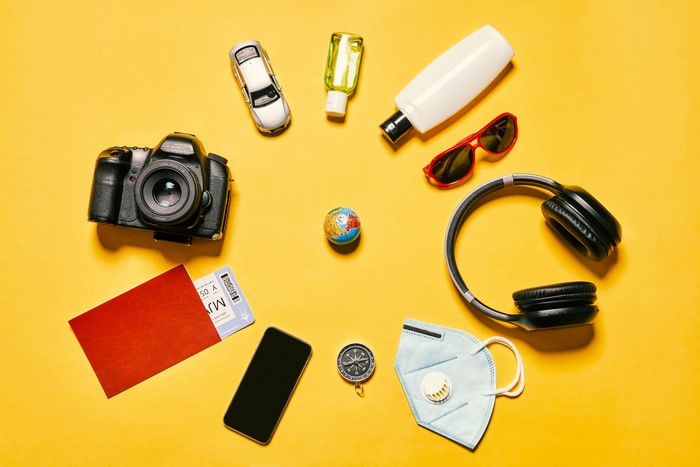 Travel essentials: camera, passport, mask, headphones, sunglasses, and more