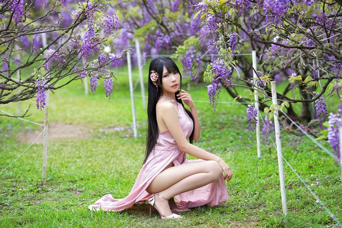 4K Asian Girl Sitting Among Flowering Trees