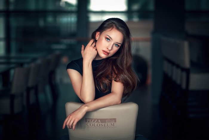 Brunette girl with hands near face