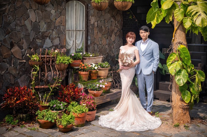 Bride and Groom Posing with Flowers