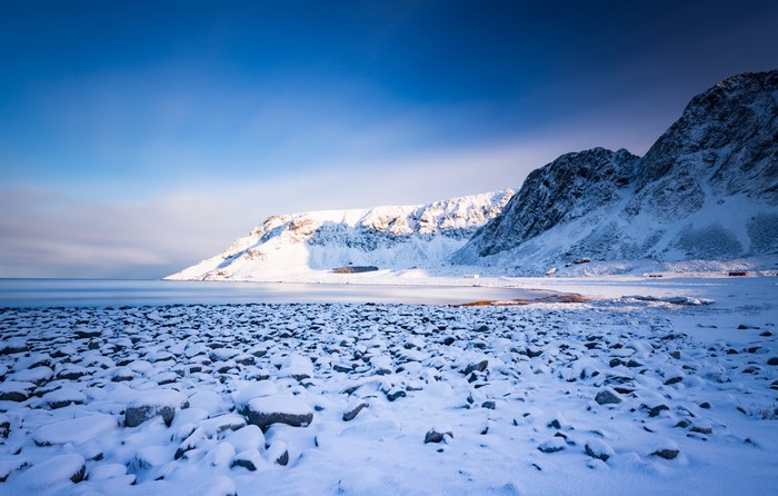 Snowy Mountains and Rocky Beach in Lofoten, Norway