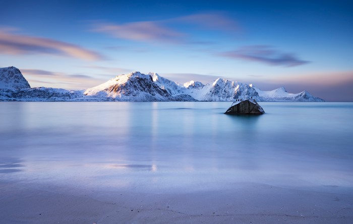 Snowy Mountains and Calm Sea at Haukland Beach, Lofoten, Norway