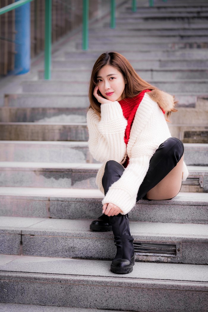 Asian Woman Sitting on Stone Stairs in Autumn