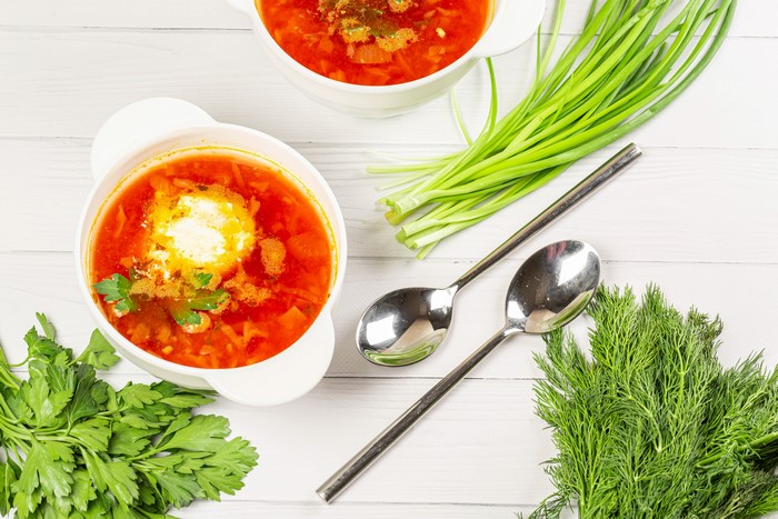Borscht with sour cream, dill, and scallions