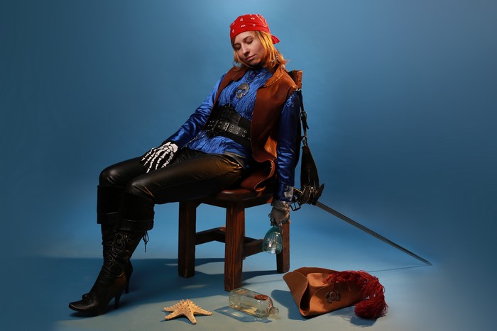 Pirate woman in costume with sword and hat