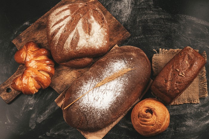 Assortment of Bread and Pastries on a Chalkboard