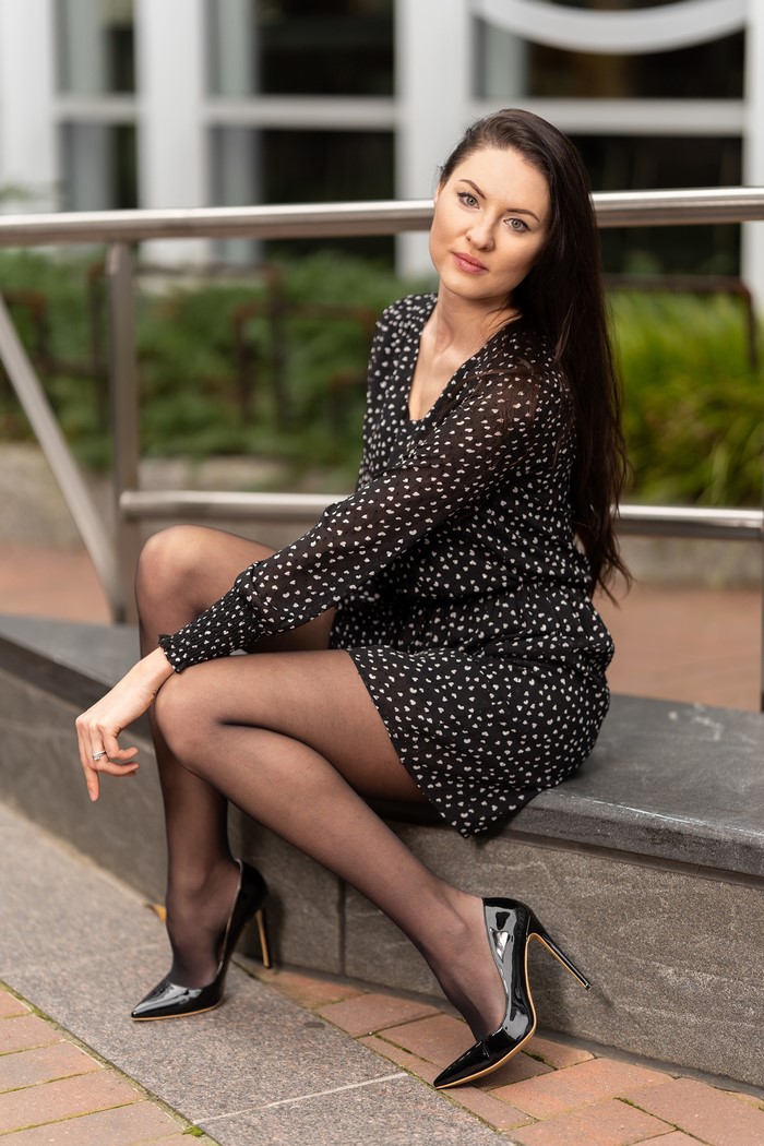Natalia Larioshina Sitting in Stylish Dress and Stilettos