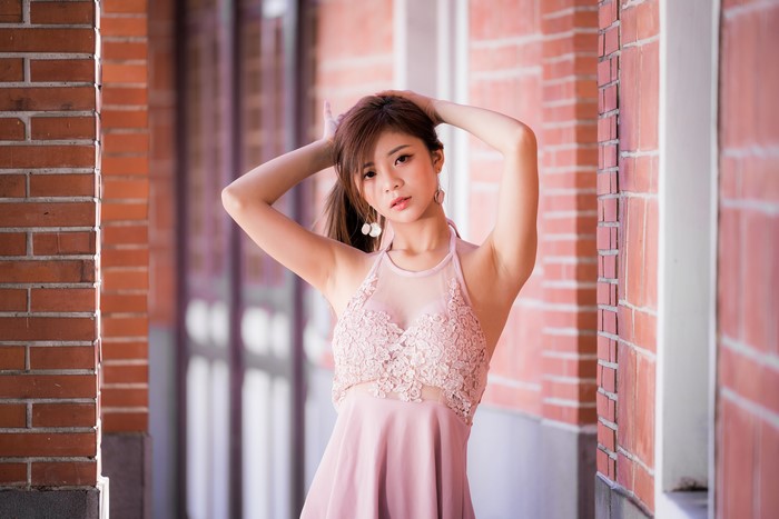 Asian woman in pink dress posing