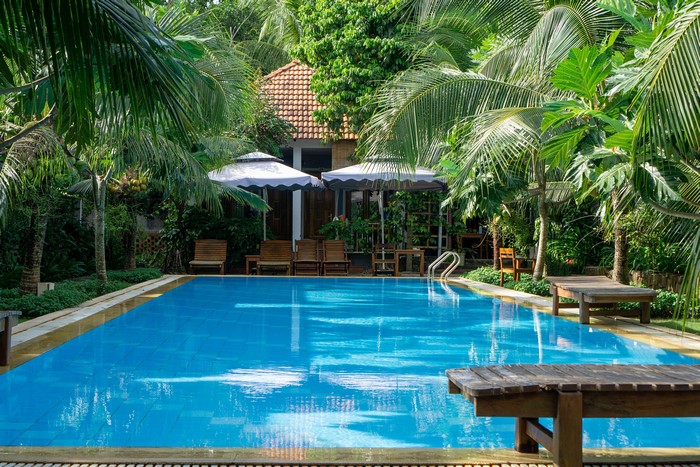 Resort pool with palm trees in Phu Quoc, Vietnam