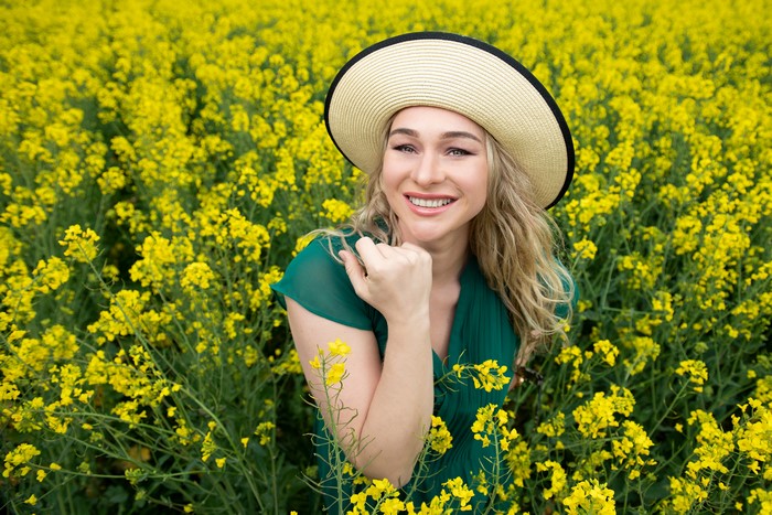Aleksandra in a Rapeseed Field Wearing a Hat