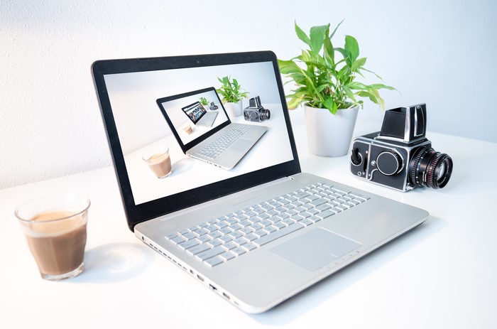 Laptop with coffee and vintage camera