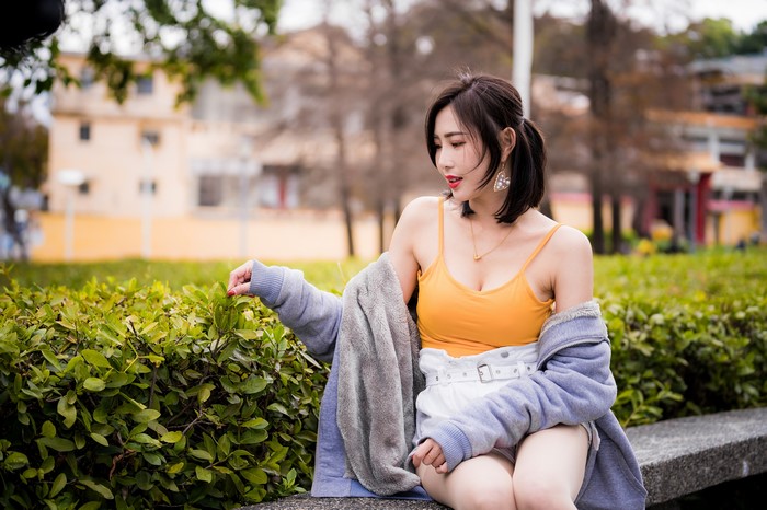 Asian woman sitting outdoors