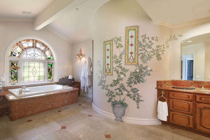 Luxury Bathroom with Stained Glass Window and Mural