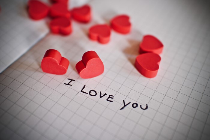 Red hearts on a notebook page with "I Love You"