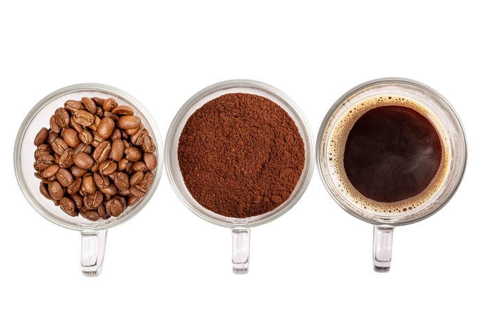 Three cups of coffee: beans, powder, and brewed