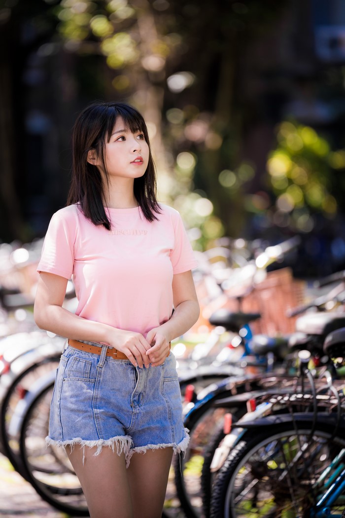 Asian girl in pink t-shirt and denim shorts