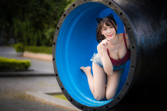 Asian woman with cat ears in a pipe