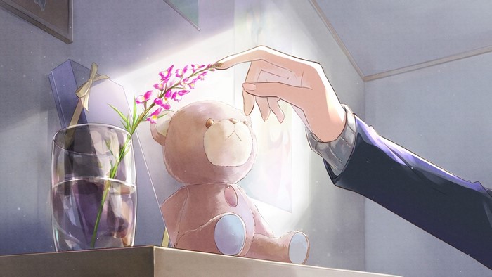 Hand touching flowers near teddy bear