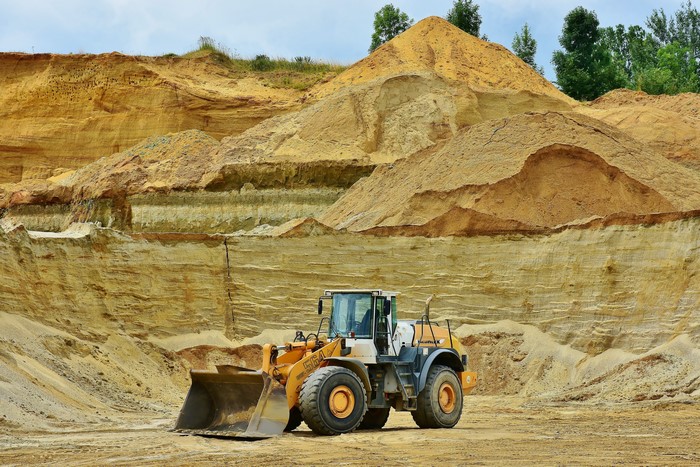 Front end loader in a sand quarry