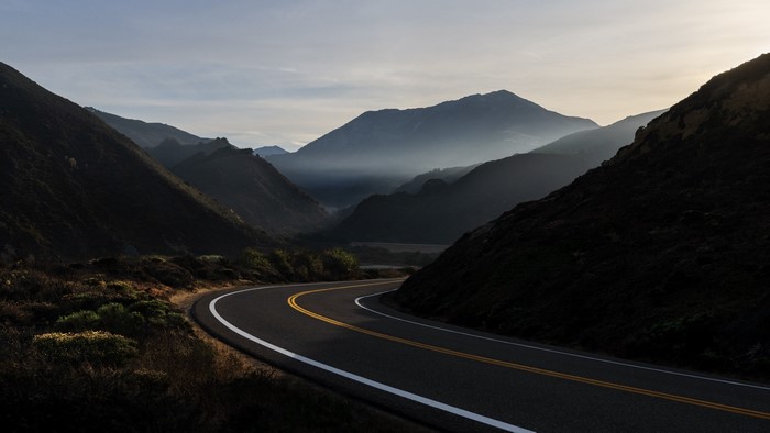 Empty mountain road with mist