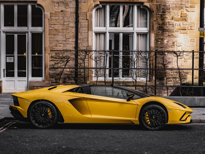 Yellow Lamborghini Aventador SVJ Roadster on a street