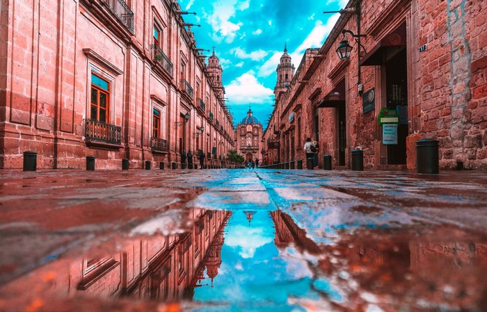 Street with reflection of buildings and sky