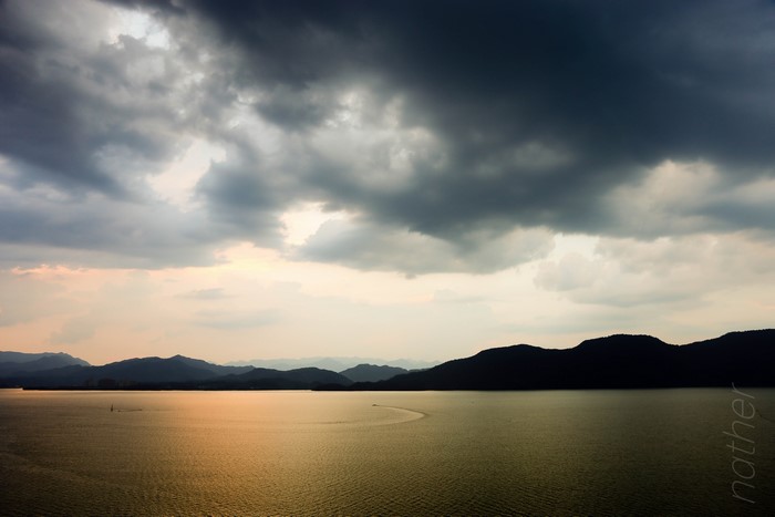 4K China lake with mountains and stormy clouds