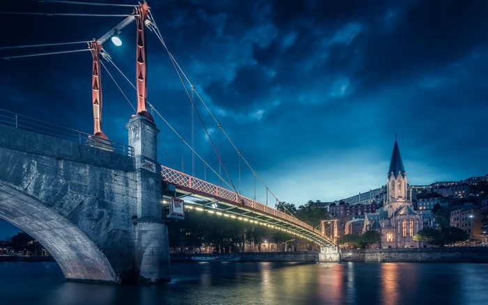 Bridge and church at night in Lyon, France