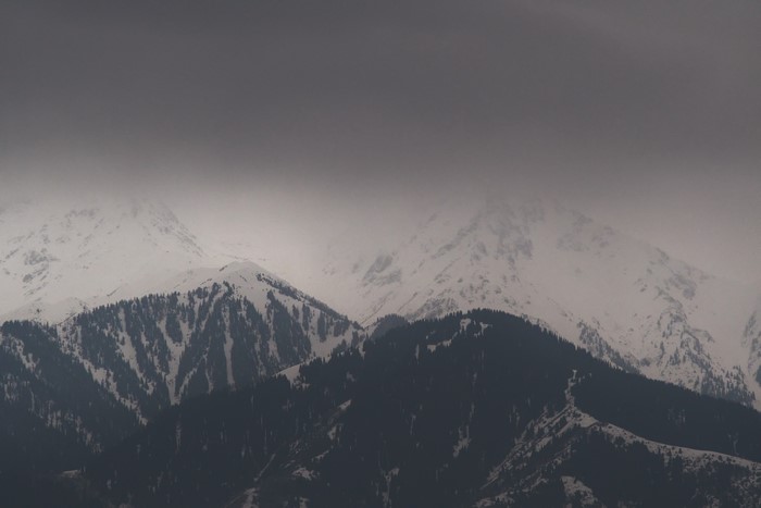 Snowy mountains with mist and clouds