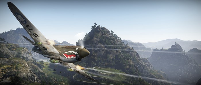 Curtiss P-40 Warhawk flying over mountains