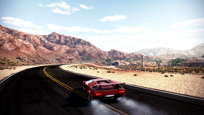 Red Lamborghini Countach driving on a desert road