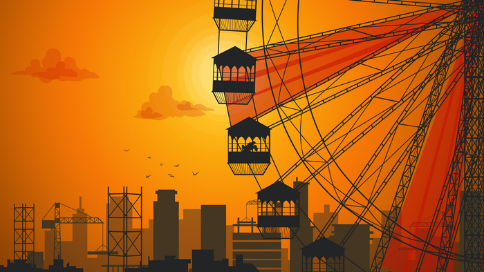 Ferris wheel and city skyline at sunset