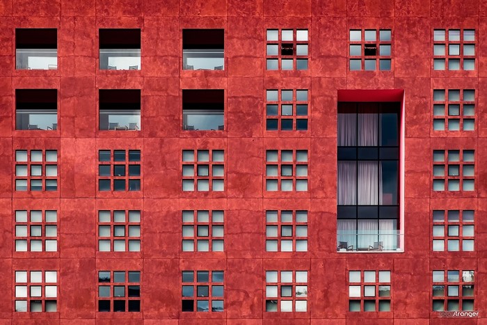 Red building facade with many windows