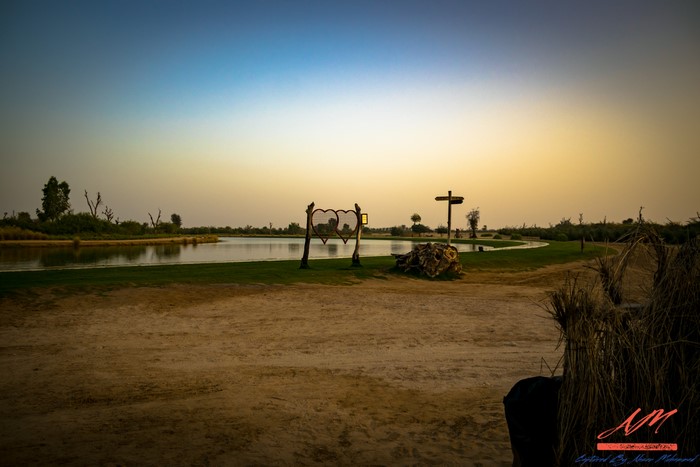 Lake and heart-shaped swing at sunrise