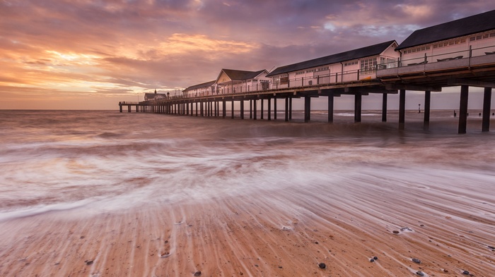 Pier over the ocean at sunset