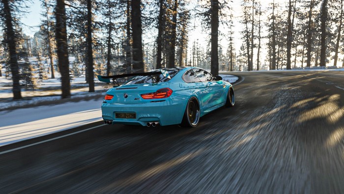 Blue BMW M6 F13 driving on a snowy road in Forza Horizon 4