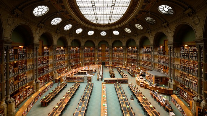 Library interior with bookshelves and reading tables