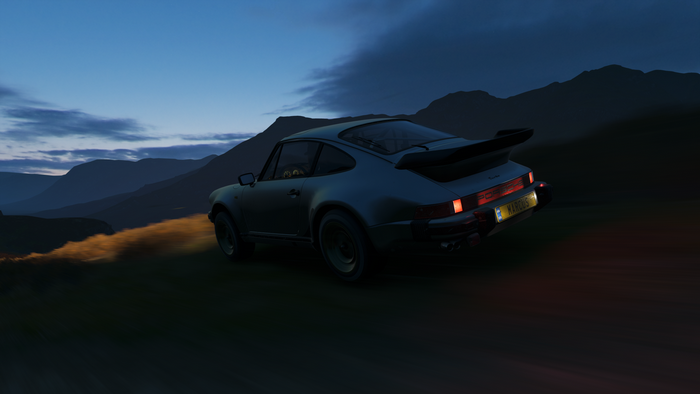 Porsche 911 Turbo driving on a mountain road at dusk