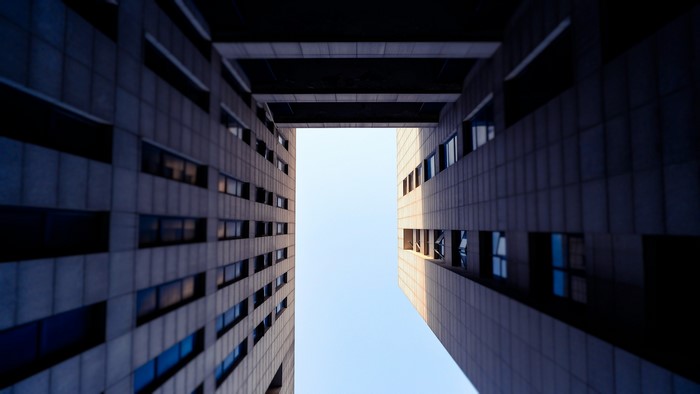 Low-angle view of modern buildings against a clear sky