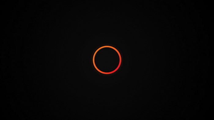 Minimalist orange circle on black background