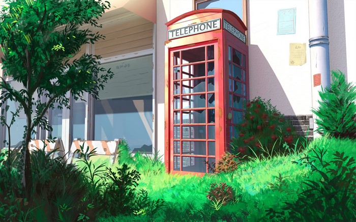 Abandoned red telephone box in overgrown grass