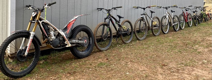 Trial motorcycle and bicycles lined up